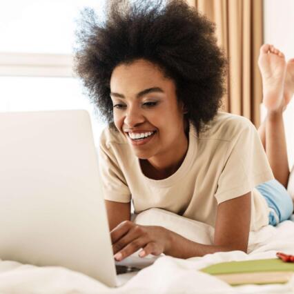 Cheerful woman using a laptop